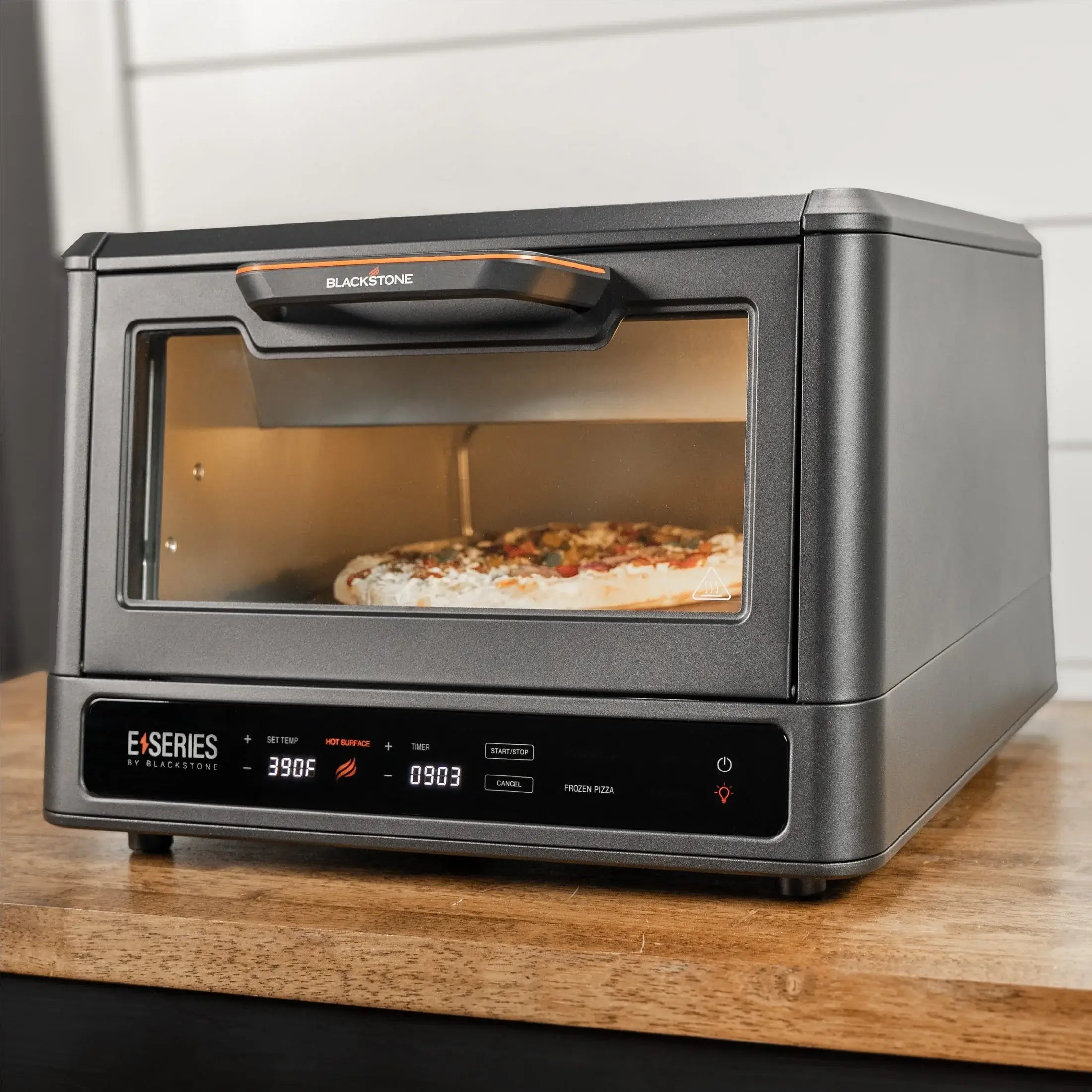 Blackstone E Series Electric Pizza Oven and Air Fryer cooking pizza on countertop