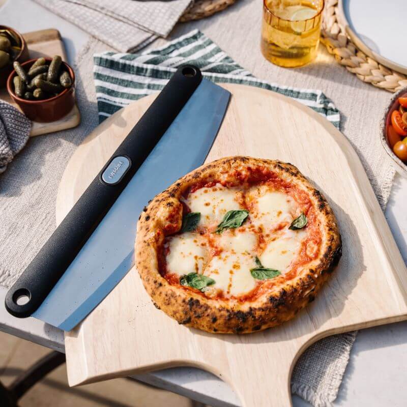 Everdure Pizza Cutter Rocker Next To Pizza