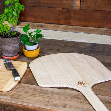 WPPO Long Handle Wood Pizza Peel on table