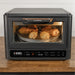 Blackstone E Series Electric Pizza Oven and Air Fryer cooking chicken