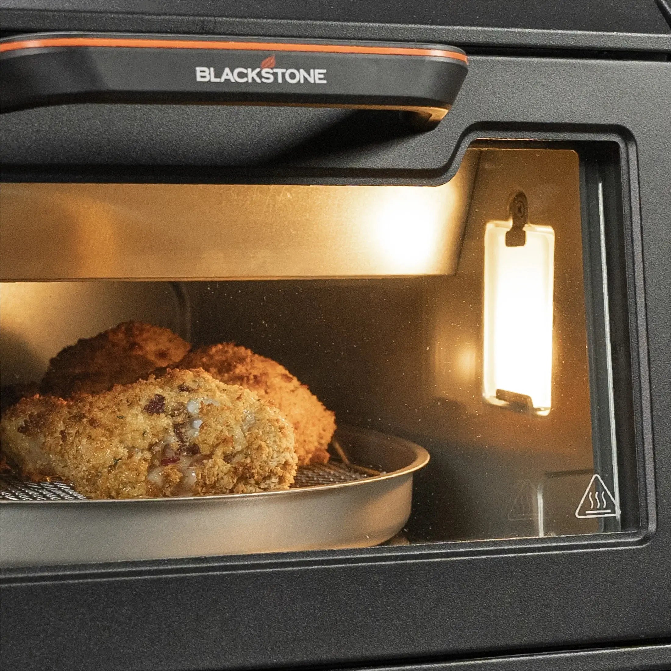 Blackstone E Series Electric Pizza Oven and Air Fryer cooking food closeup
