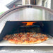 Closeup of pizza cooking in WPPO Lil Luigi Portable Pizza Oven 