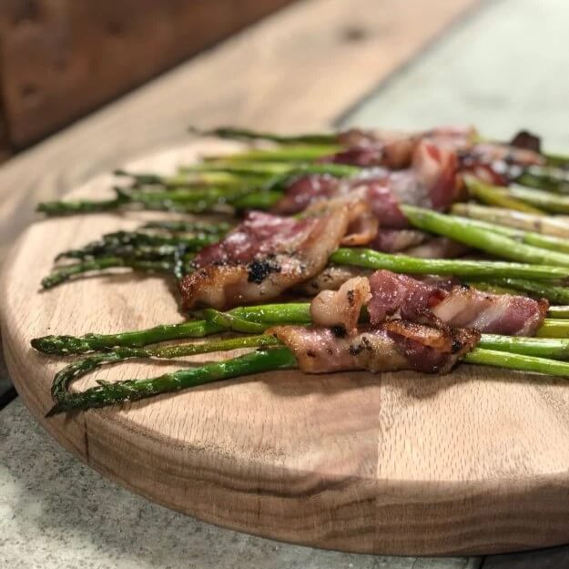 Bacon wrapped asparagus cooked in WPPO pizza oven 